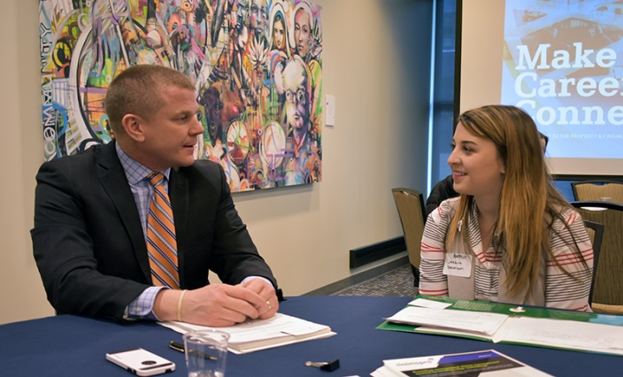 Image - male insurance professional networking with young female student.